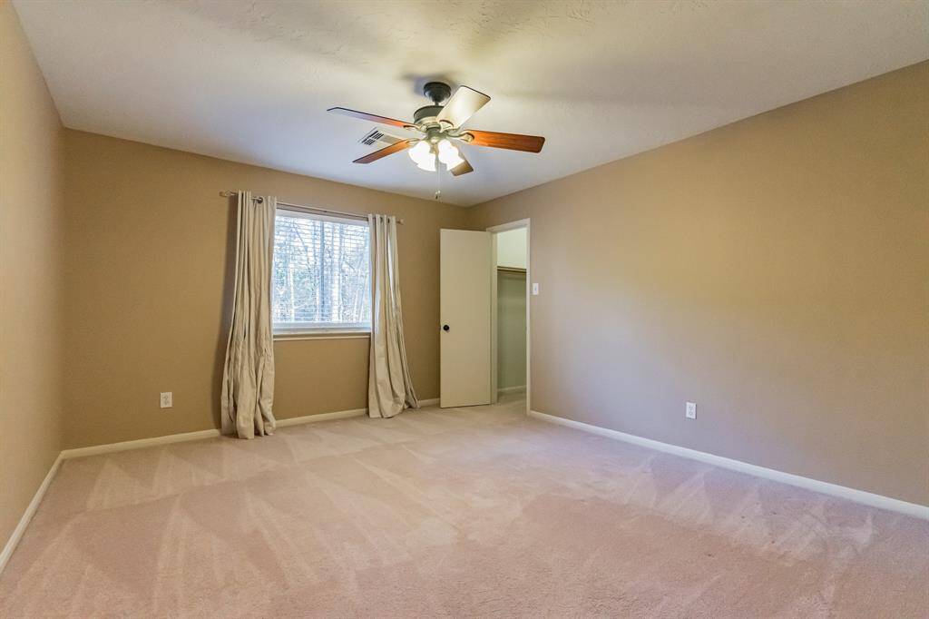 2nd secondary bedroom with large walk in closet and ceiling fan