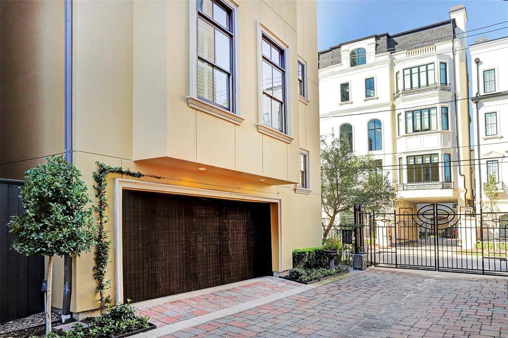 Pristinely manicured landscaping and brick paver drive serve as the anchor for this exceptional home. Stained door to two car garage adds a layer of character to its exterior.