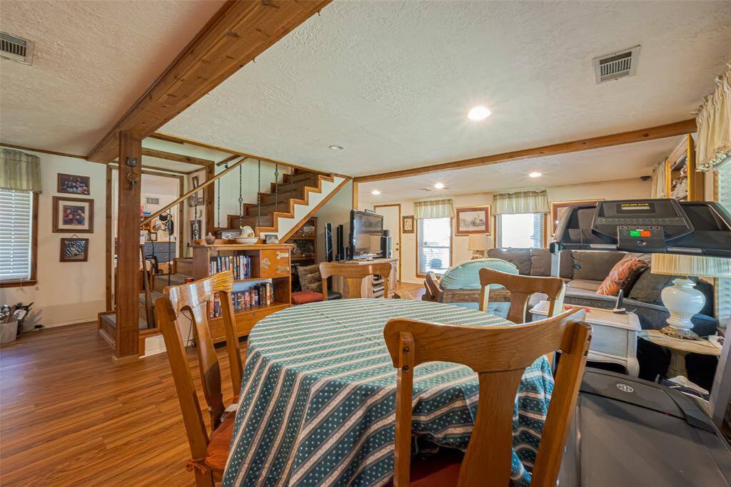 Another view looking towards the front door and living area.  The stairs take you up to 3 bedrooms and a full bath. There is additional space under the stairs to be used as you wish.