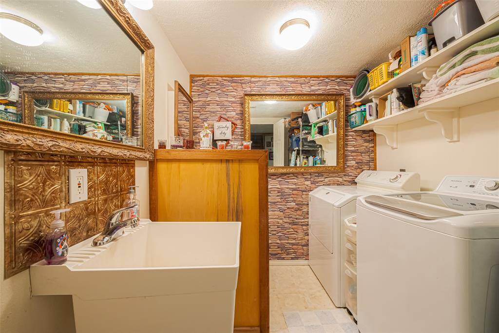 The laundry room and half bath are combined! There is plenty of storage space behind the door as you walk in
