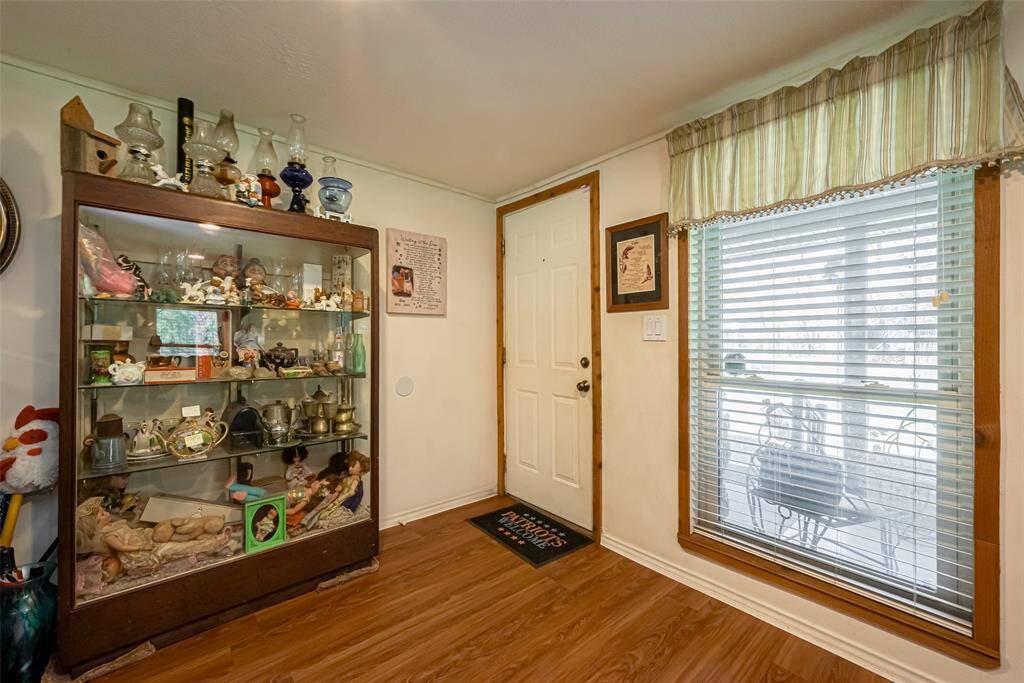 Front door right off the porch inviting you into the living area with lots of space for family and friends.
