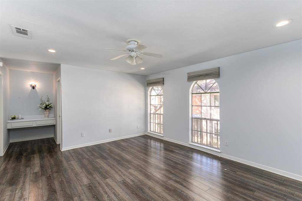 This spacious primary suite offers a separate dressing area/powder nook and 2 large walk in closets.