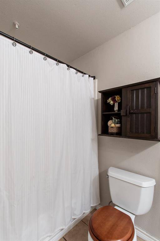 View of the tub shower in full bathroom upstairs.