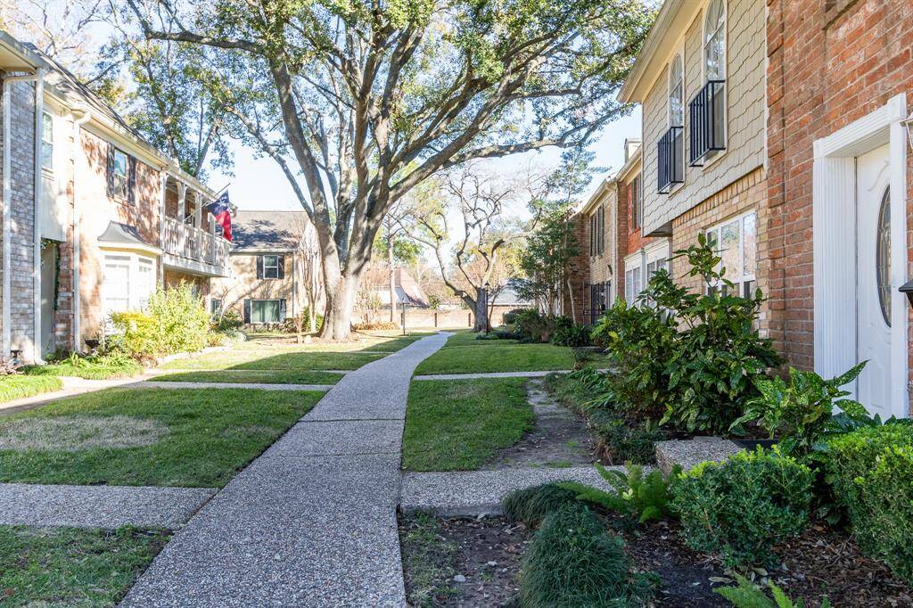 Beautiful complex with tree s and nice landscaping.