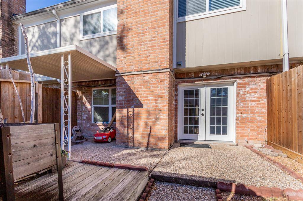 Backyard area with covered patio and nice decking.