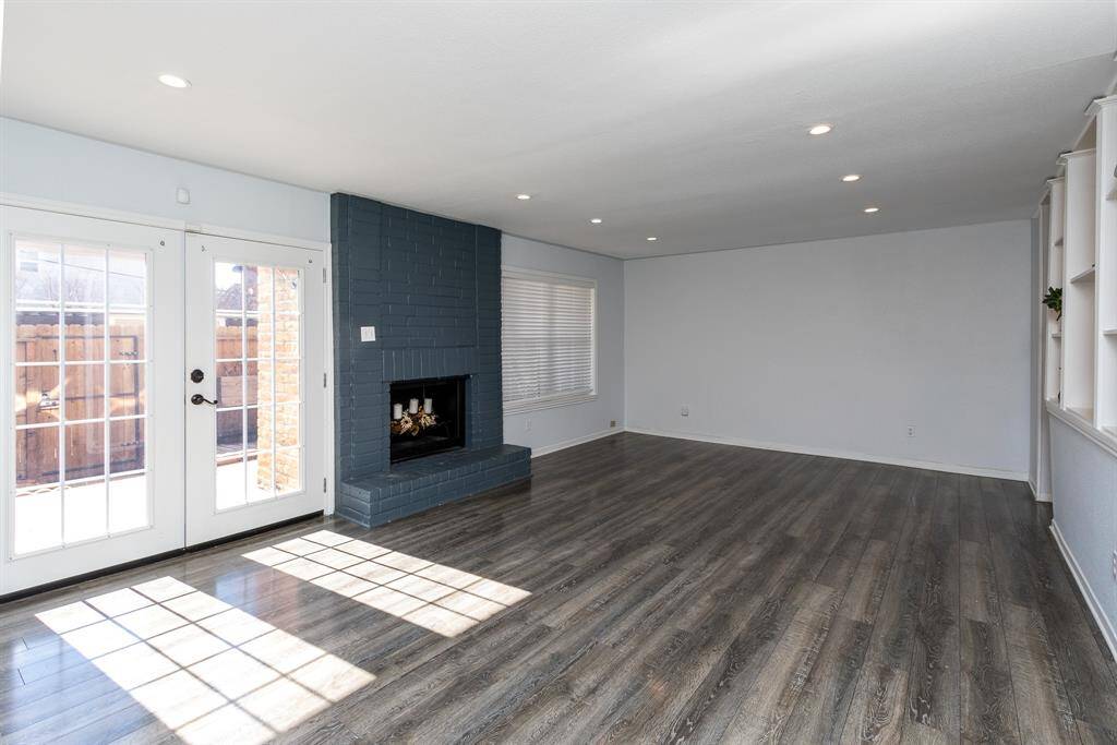 The inviting family room has access to the covered patio and covered parking + outdoor storage.