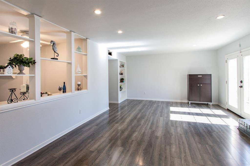 The family room has built in shelving and is adjacent to the kitchen.
