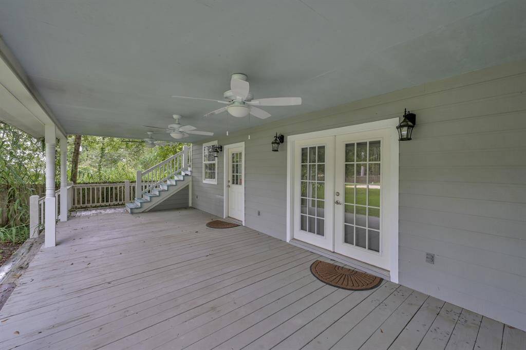 Lovely porch with ceiling fans allows the breeze to cool you off after working.