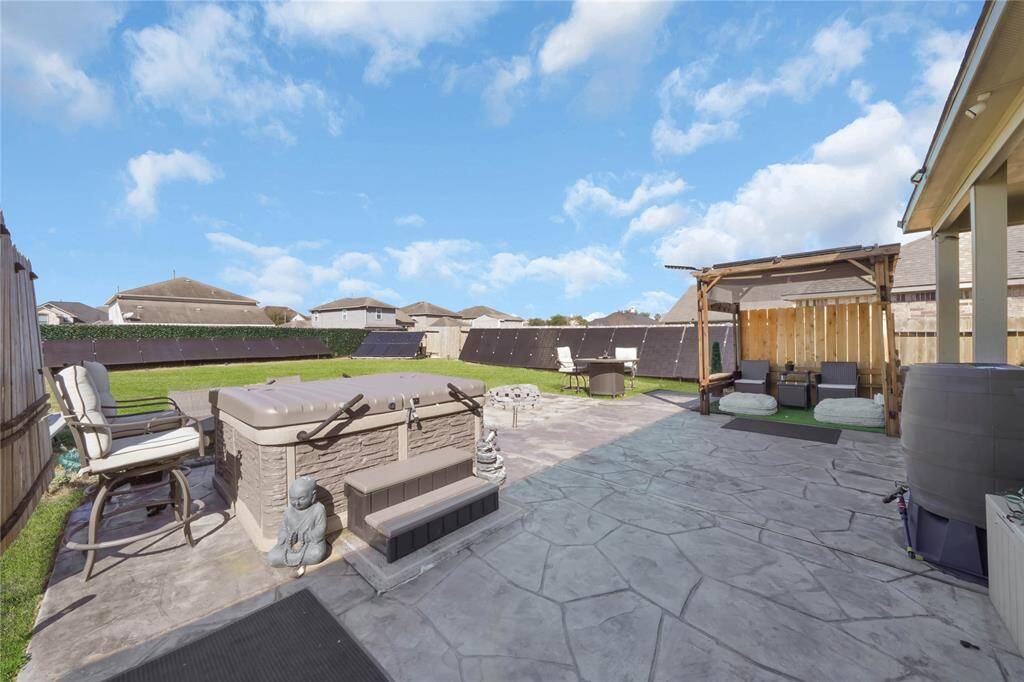 Backyard stamped concrete, solar pergola and negiaotable hottub.