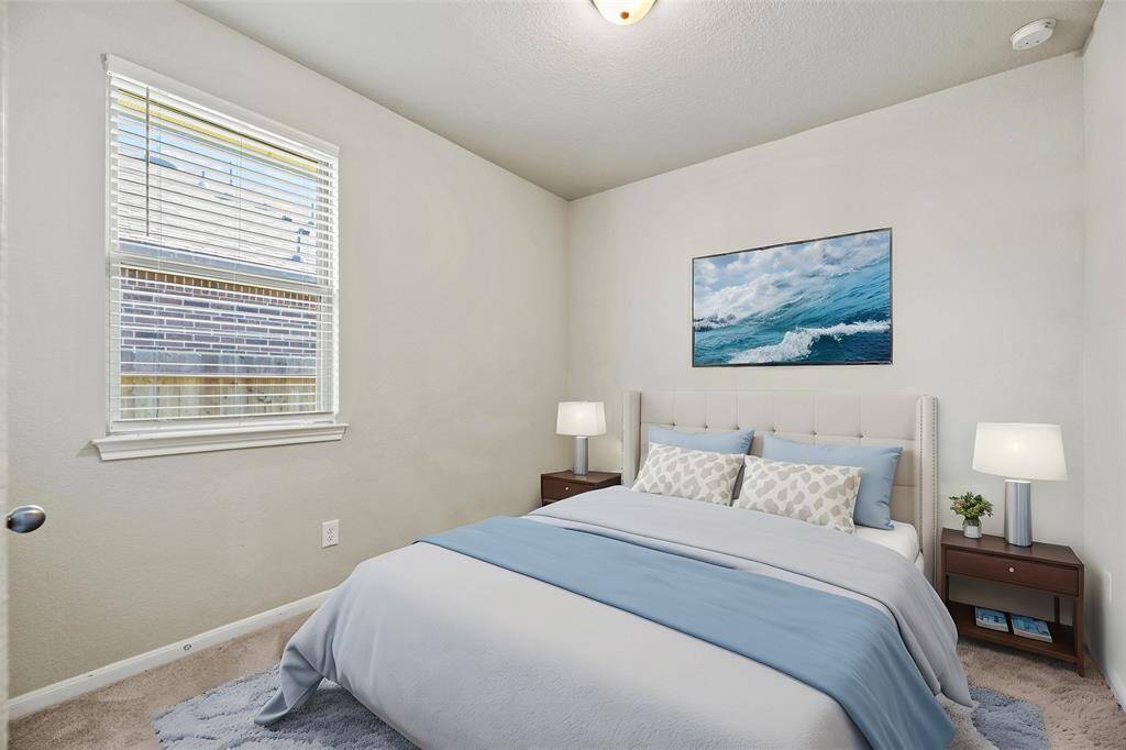 The thoughtfully designed third bedroom allows for natural light to flood the room, creating a warm and welcoming atmosphere.