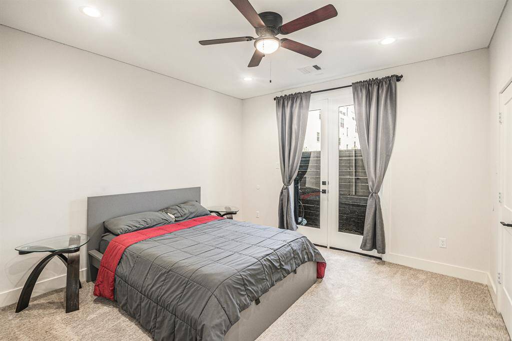 Additional view of downstairs bedroom.  This bedroom is spacious and modern, featuring neutral walls, a ceiling fan, and recessed lighting.
