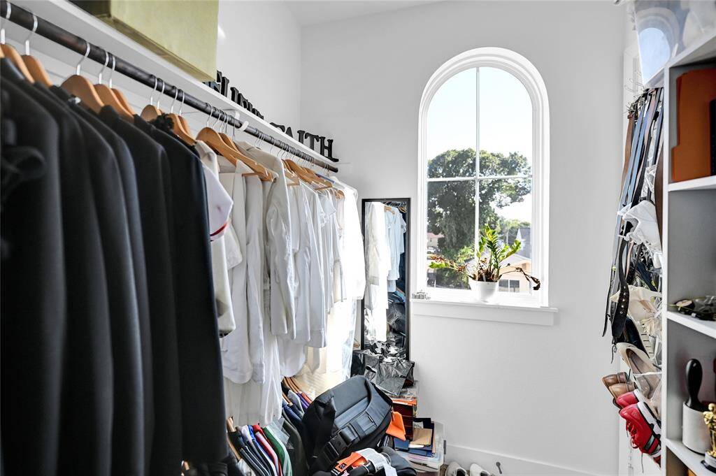 Primary bedroom's large walk-in closet with additional nook for storage.