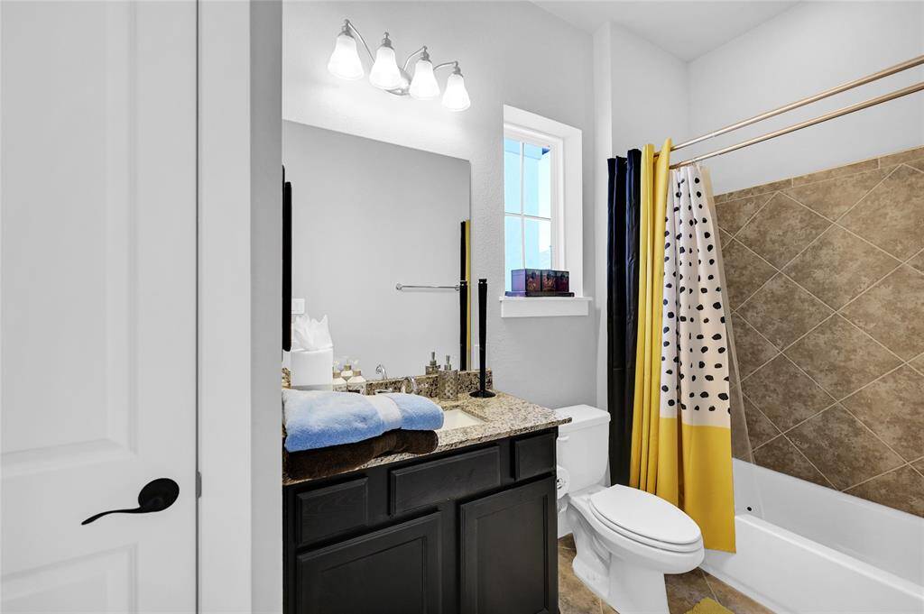Bathroom #3 - combo tub & shower.  Window offers natural light