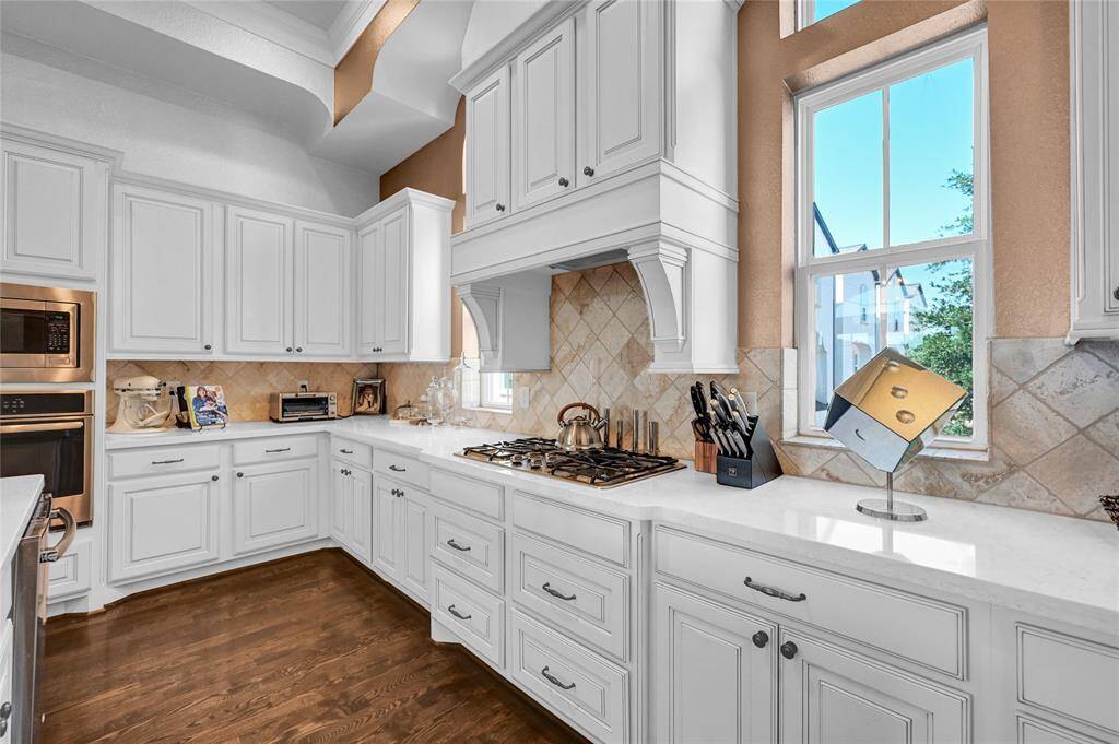 Gorgeous and spacious kitchen with custom cabinets offering plenty counterspace of storage.