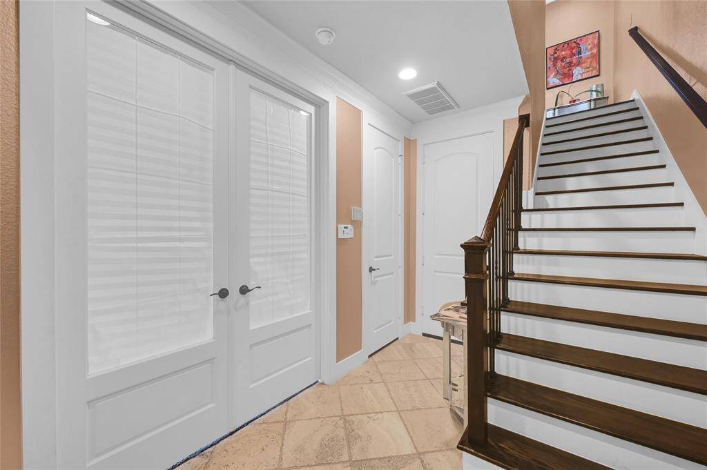 View of home entrance featuring Travertine tile.