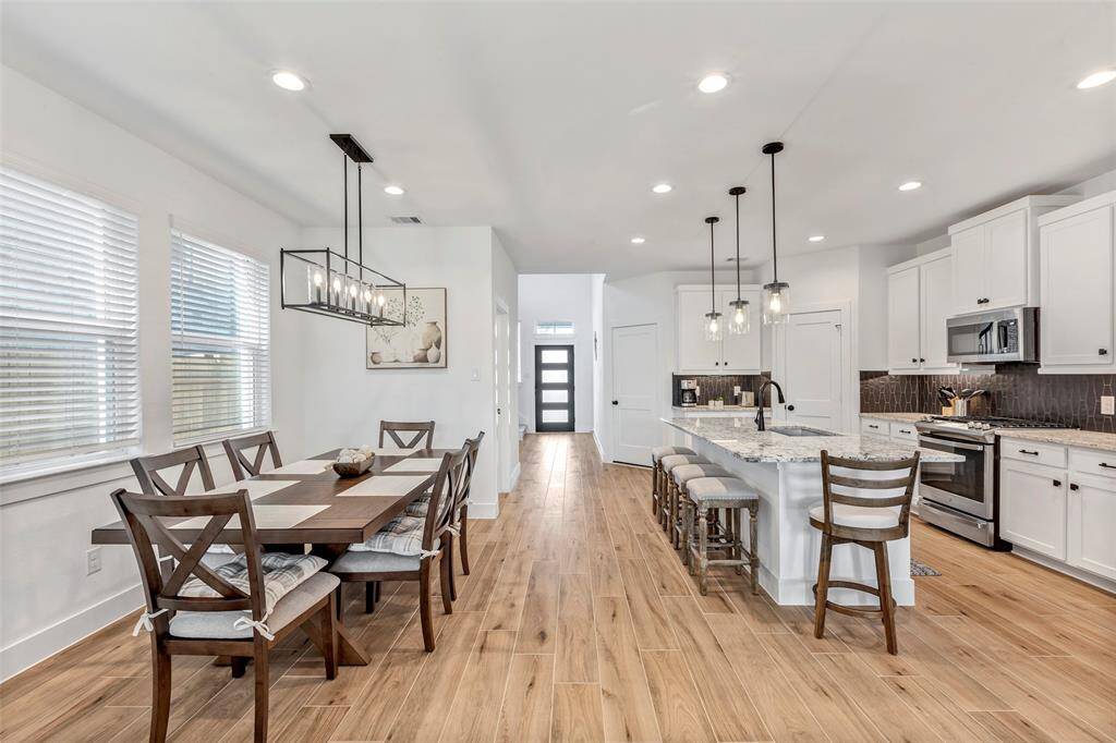 Dining area offers natural light through multiple windows, creating a bright and inviting atmosphere.
