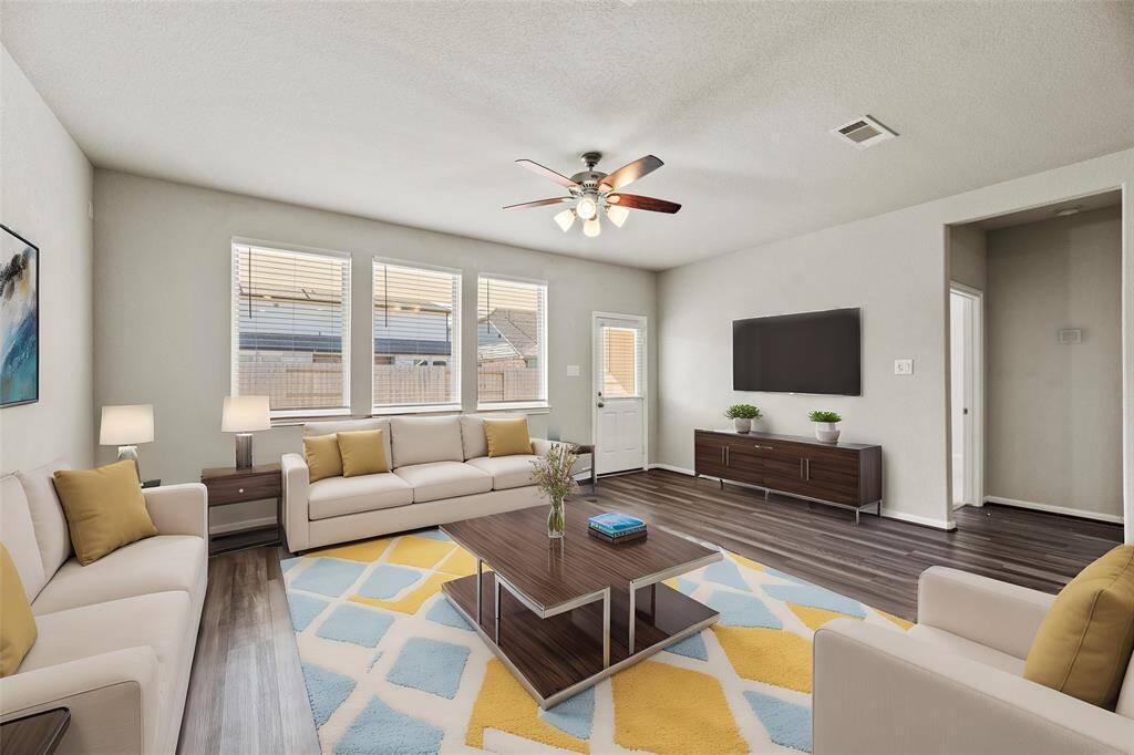 This chic living room space has a great feel with tons of natural light coming from the wall of windows.