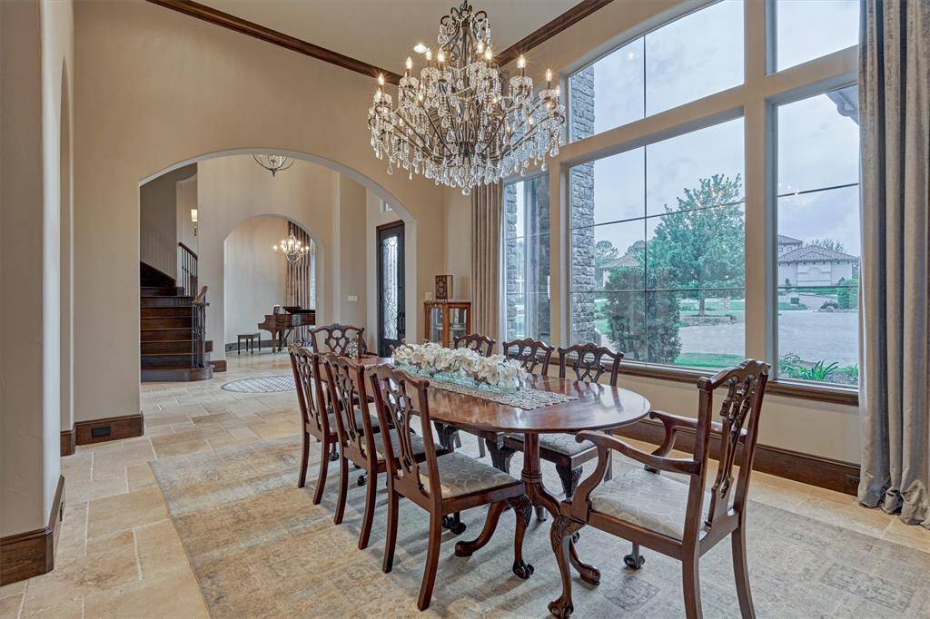 A spacious formal dining room to the left of the entry is filled with natural light from the window overlooking the front yard. A crystal chandelier creates a grand focal point.