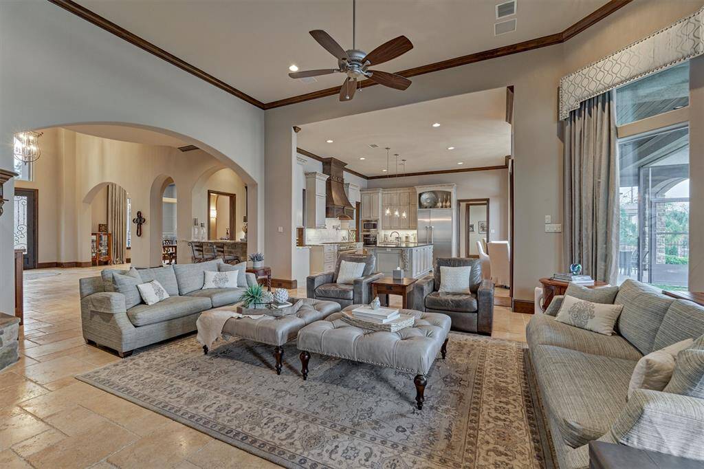 The living space is open to the kitchen and breakfast areas with a luxurious travertine flooring.
