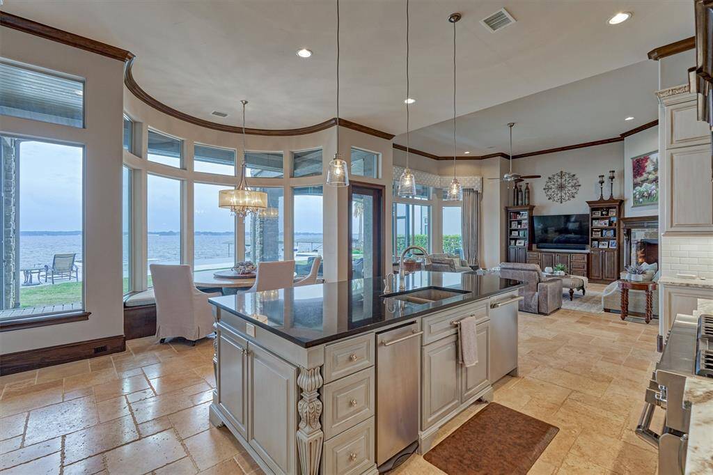 The wide expanse of windows in this area provides a stunning panoramic view of the lake. With its eastern exposure, this home offers beautiful sunrises and comfortable afternoon shade.