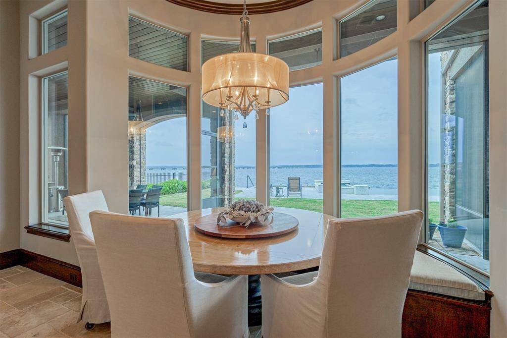 A quaint breakfast area provides a custom curved bench seat for more casual gatherings.