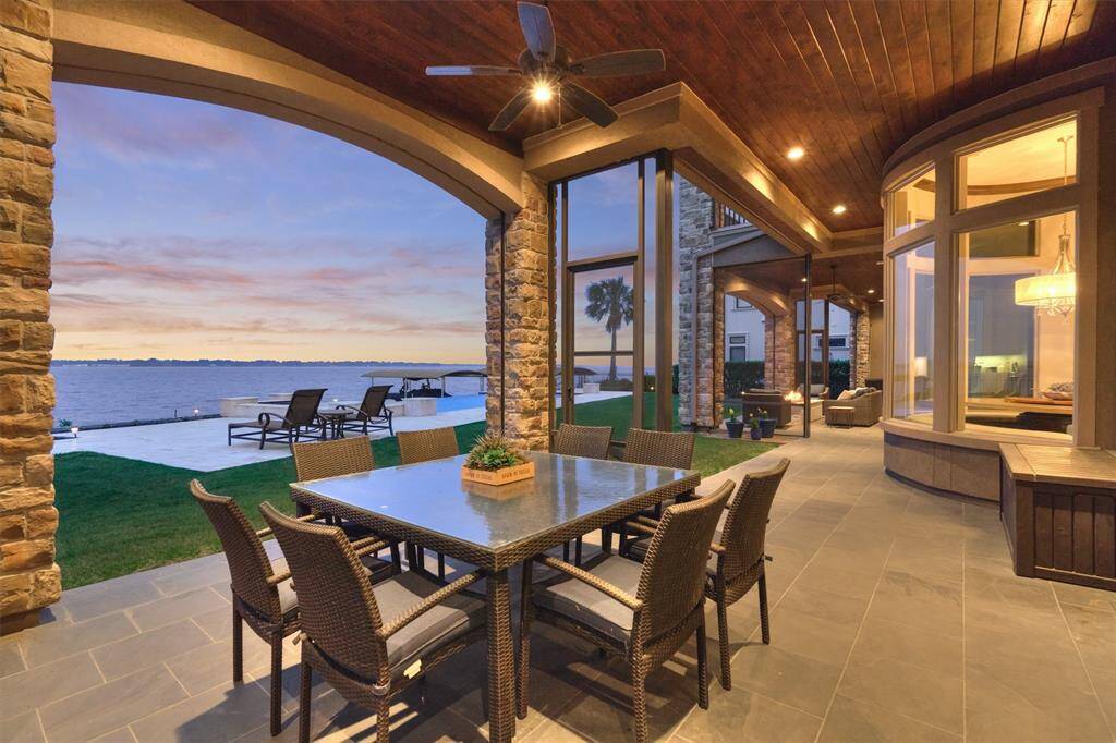 Regardless if you enjoy a screened in porch or wide open views, you can have both with retractable screens that cover the length of this first floor porch! Beautifully finishing out this space is a stained wood ceiling with recessed lighting.