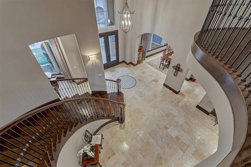 This view shows the beautiful millwork and curvature of the stairs. On the second floor, we will find a game room, two bedrooms, three full baths and a second office/5th bedroom.