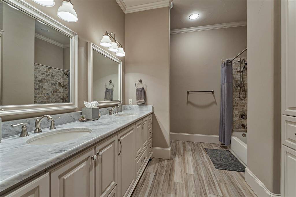 This ensuite bath also features double sinks, a tub and shower as well as pull out steps under the sinks for little ones and an abundance of storage cabinets.