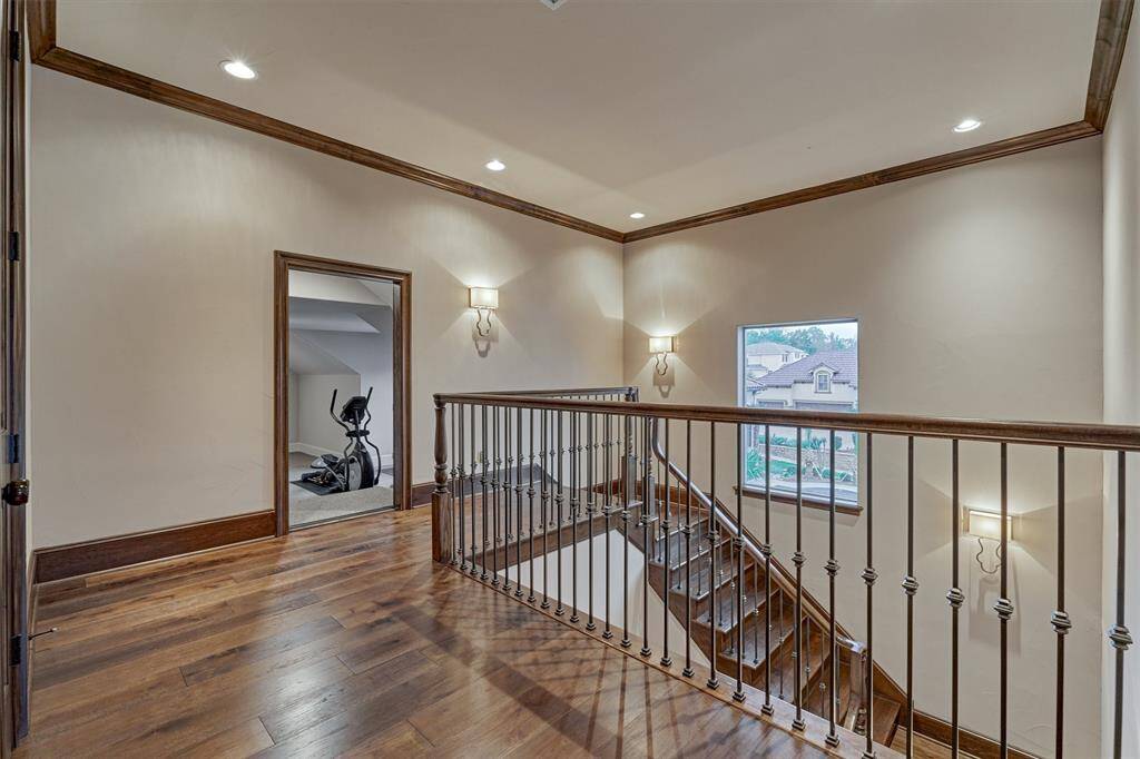 A back stairwell leads from the back of the kitchen and laundry area up to an extra room that was finished out for a home gym. There is also a massive storage closet that is perfect for storing holiday totes, linens and more!