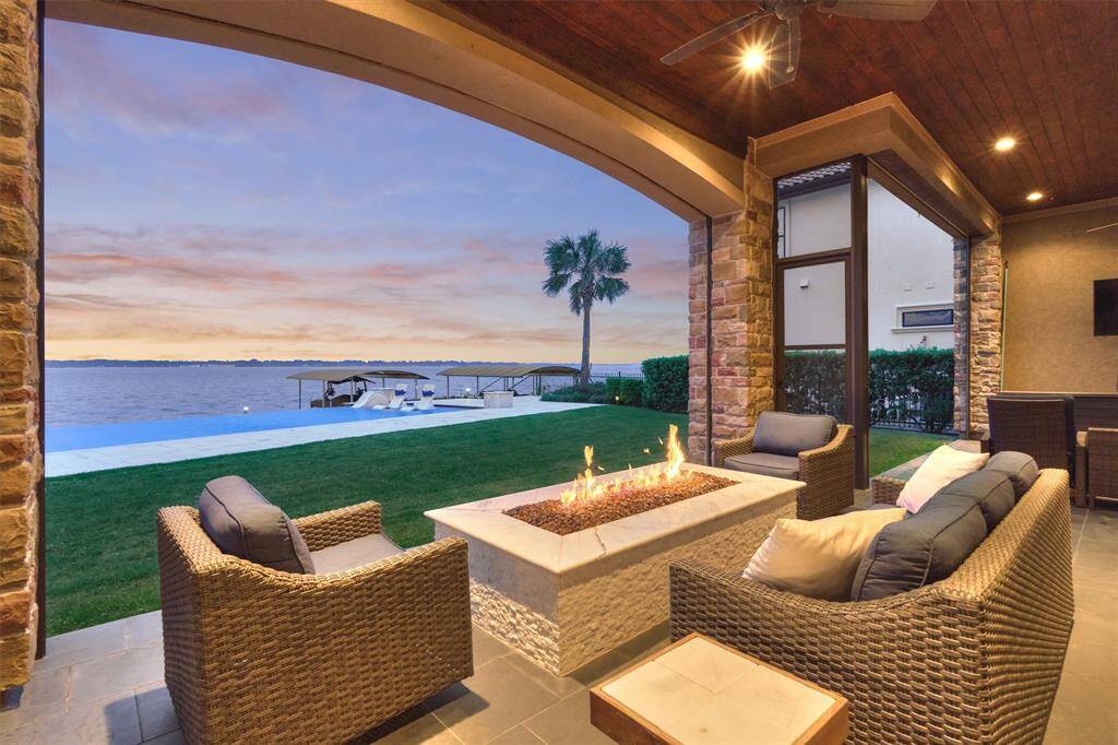 The covered porch offers retractable screens and rich wood stained ceilings.