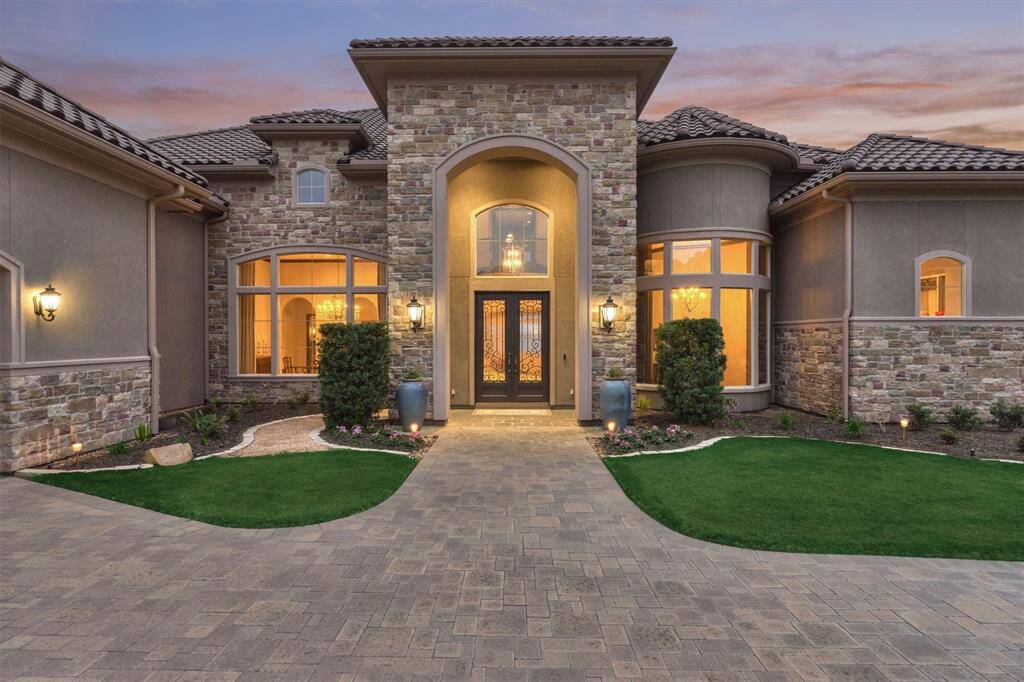 The stone paved driveway and front walk create a grand entrance to this home.