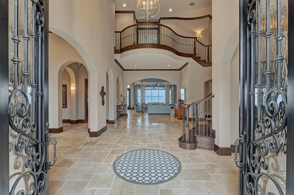 Upon entering the home, you are greeted with a 20 foot ceiling and stunning open water views.
