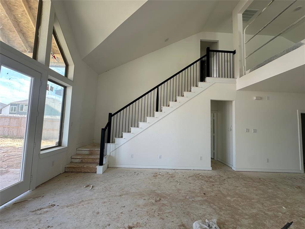 UNIQUE STAIRCASE LOCATED TOWARDS THE BACK OF THE HOME