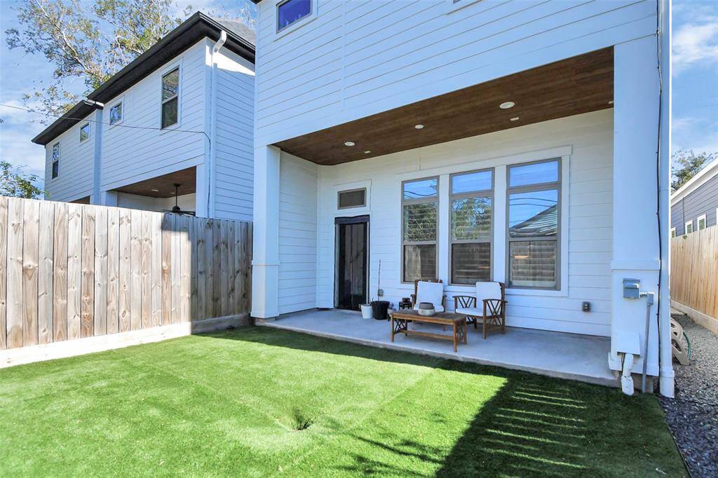 Turfed backyard, and covered patio.