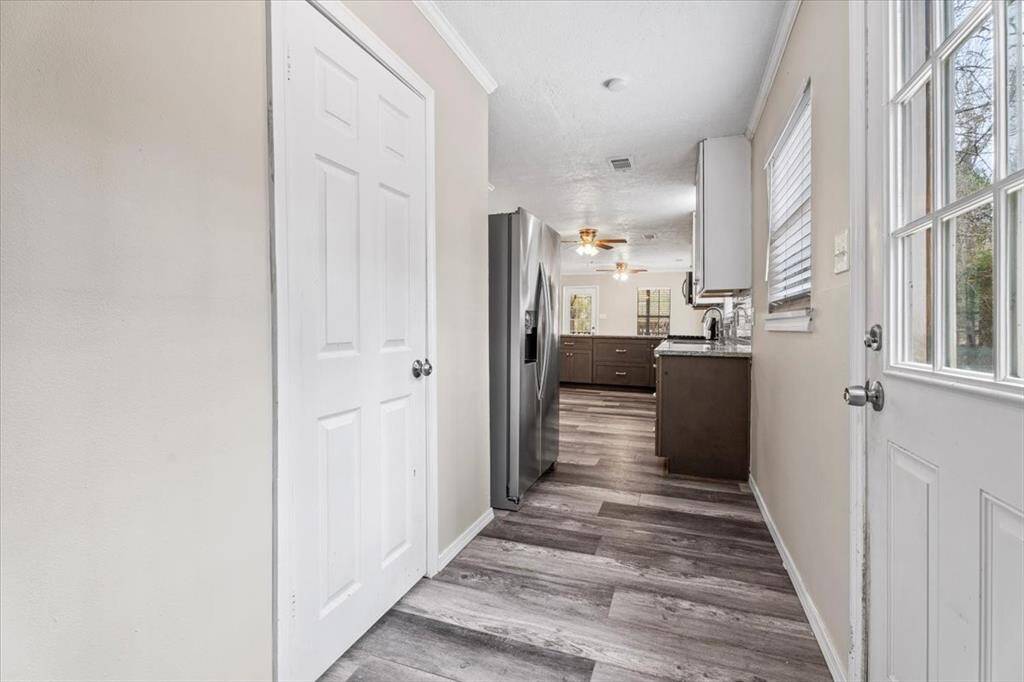 Hallway to PANTRY, back door access and laundry room.