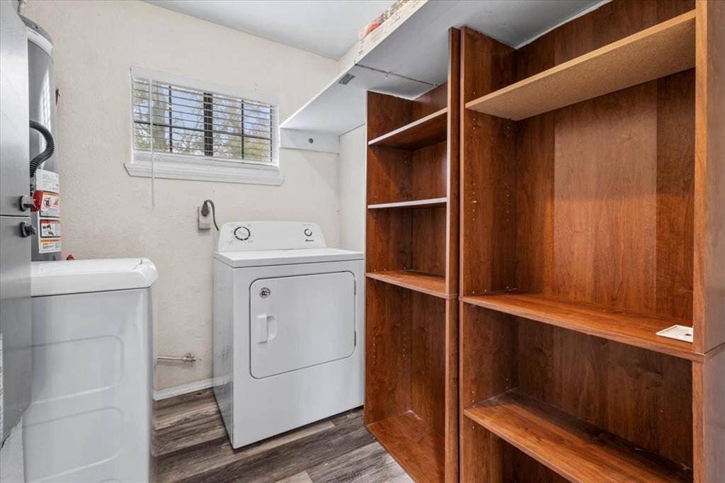 First floor laundry room with shelving for storage!
