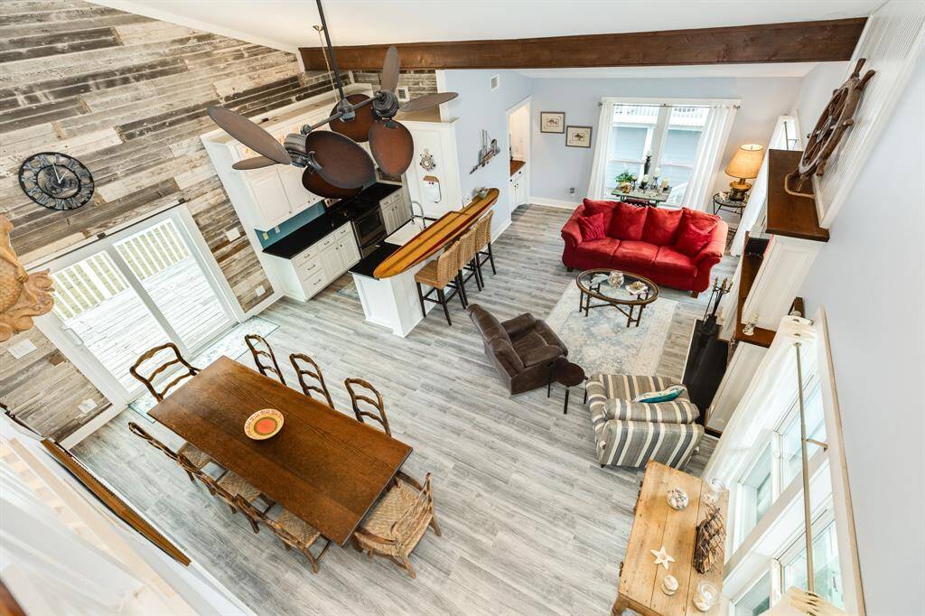 This is a view from the 2nd floor hallway down into the dining area, living room and kitchen area. Note the reclaimed lapped siding on the east wall.