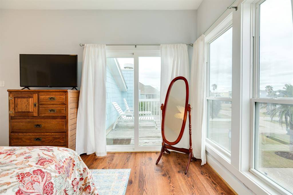Primary bedroom also has a doorway leading out to the private balcony.