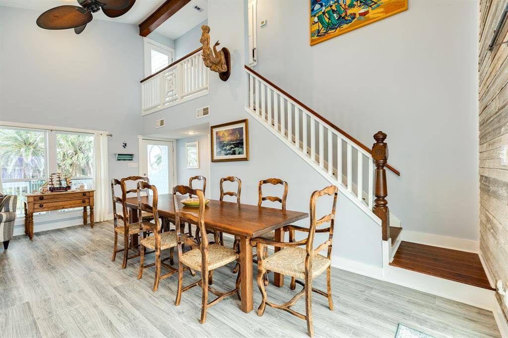 The dining area is bright and open thanks to the many windows and sliding glass doors not in view that open to the east facing deck.