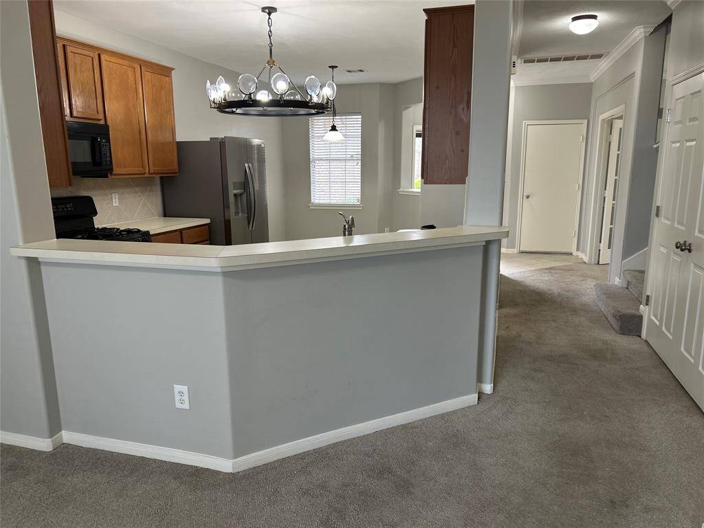 HERE'S ANOTHER VIEW OF THE OPEN CONCEPT KITCHEN FROM THE LIVING ROOM