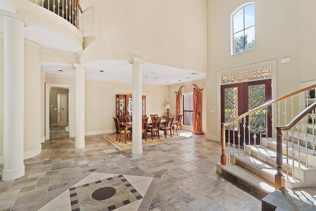 Soaring 2-story ceilings create a grand formal entrance to this stunning luxury home.