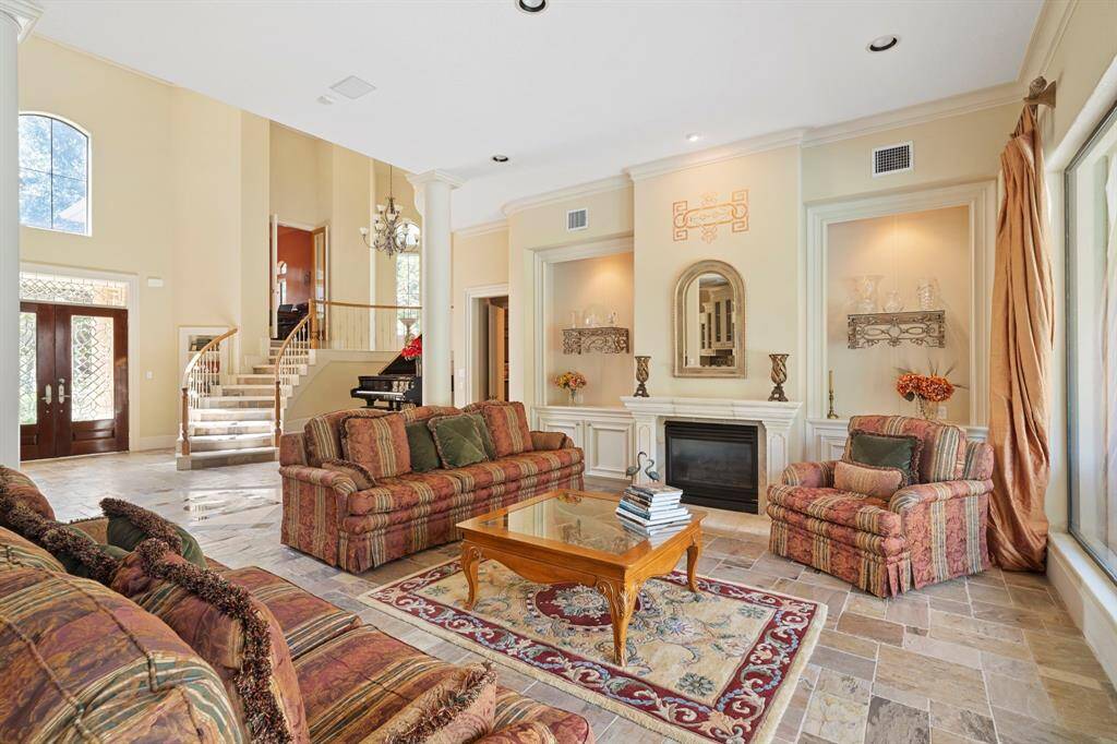 3 fireplaces in this home! The formal living room fireplace is bordered by built-in cabinets and lighted wall niches for art or shelving.