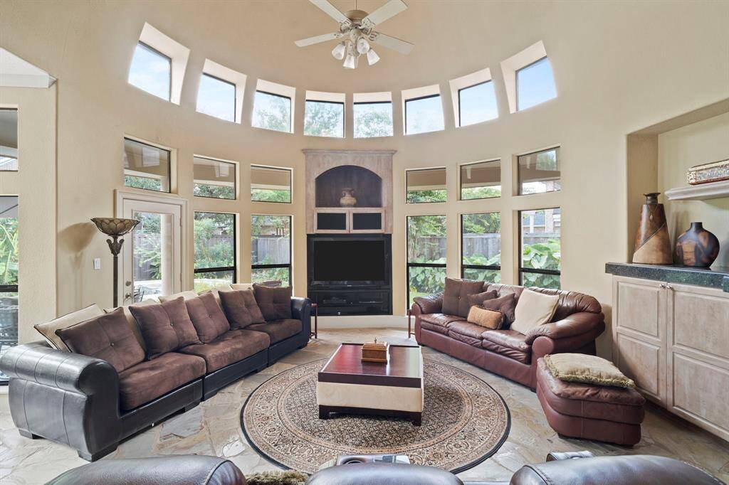 Curved wall "rotunda" with floor-to-ceiling windows fill the family room with natural light.