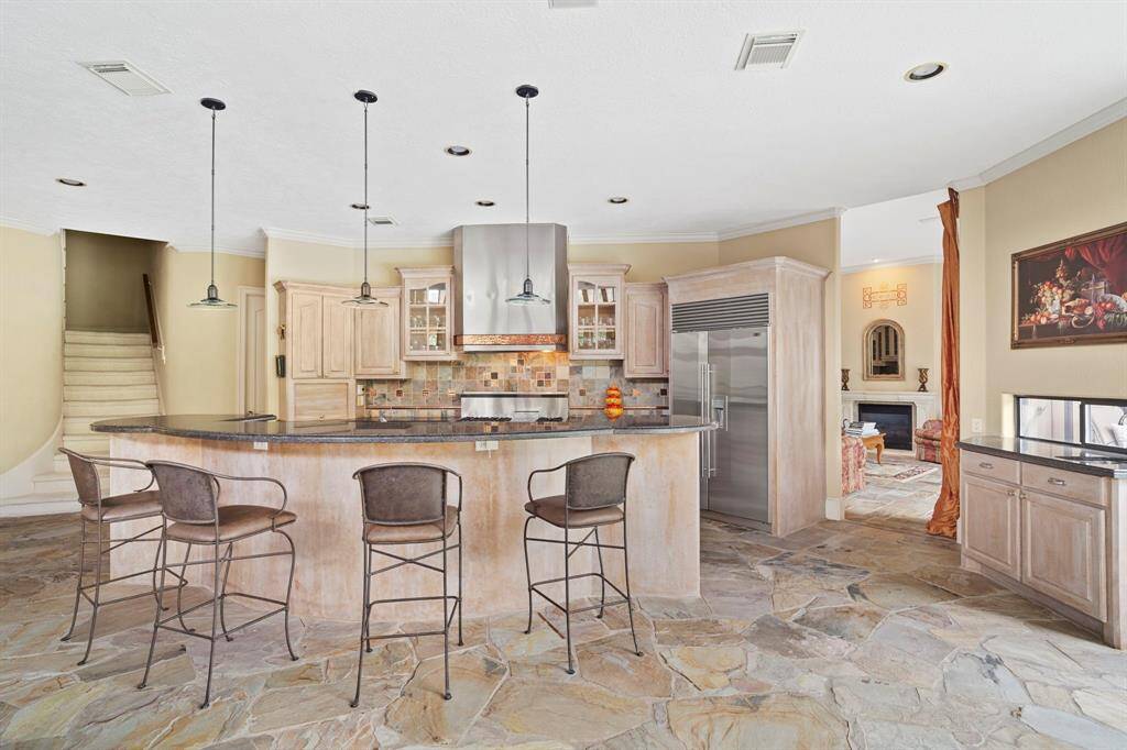Natural stone, slate flooring continues through the main living areas to create a cohesive, unified look.