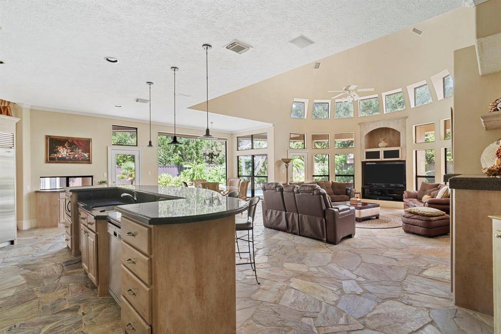 Magnificent great room with high ceilings, custom built-ins, and large windows with relaxing views.