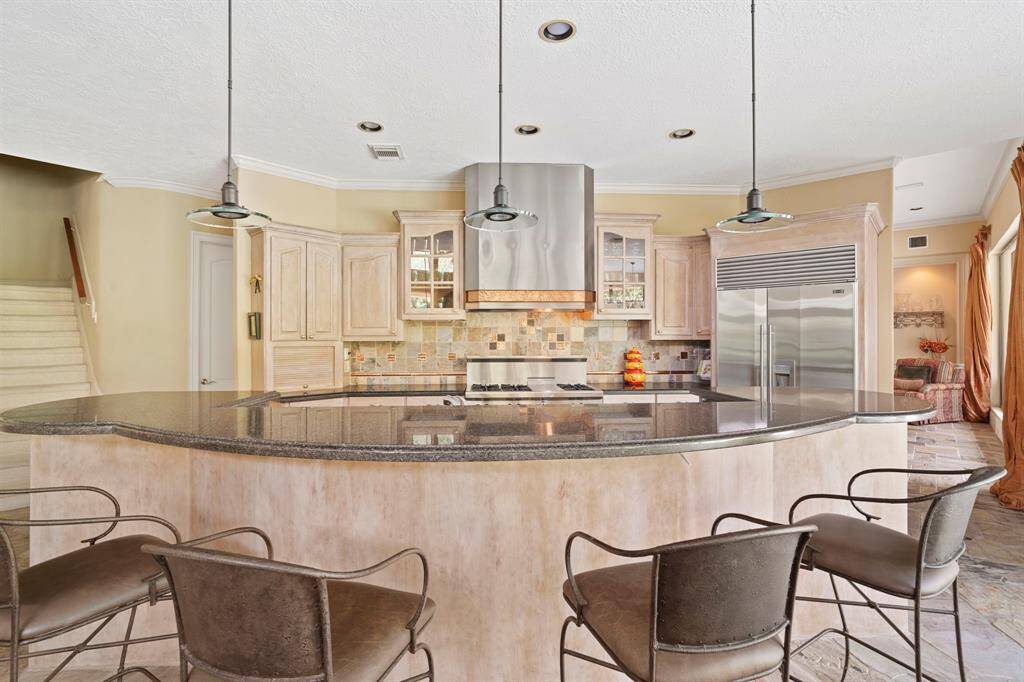 Welcoming breakfast bar is a social hub in this well-thought-out kitchen.