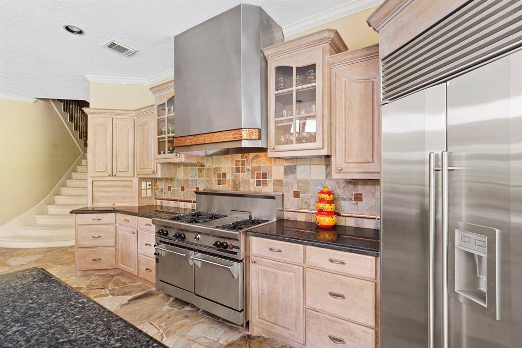 Second staircase makes it easy for in-laws or guests to access the kitchen from the upstairs owner's suite.