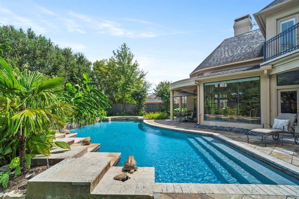 Gradual step entry pool. Slate patios add to the natural beauty of the outdoor living space and are also durable and water-resistant.