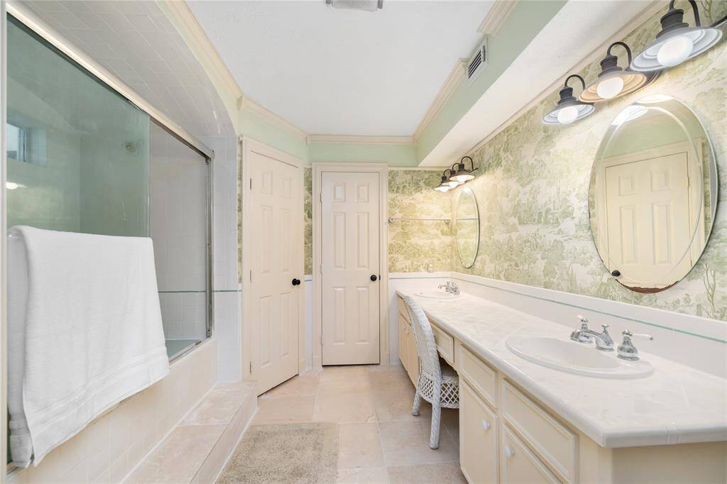 The Primary Bathroom has dual sinks with a vanity seat, making it easy to share the space