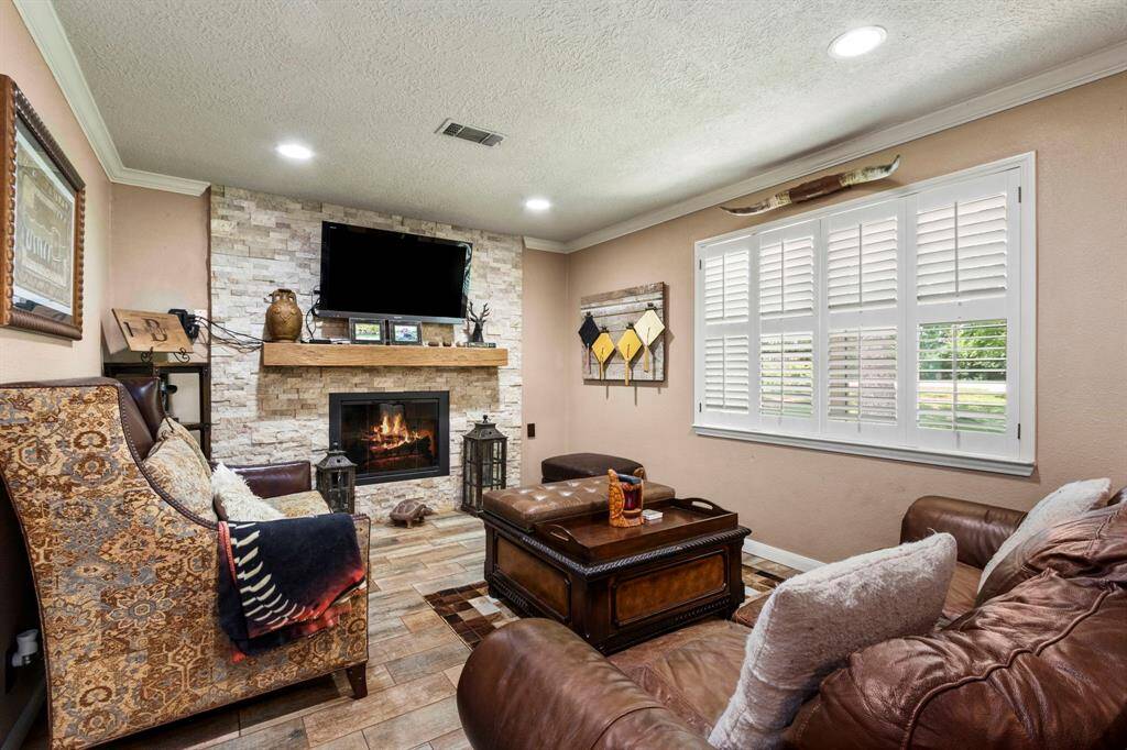 Living room has new fireplace front, stone and mantel. There is also crown molding and plantation shutters throughout the home.